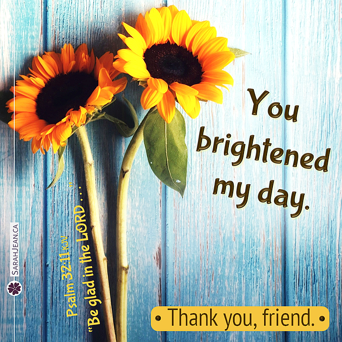 Free SarahJean Friendship eCard with a Christian message entitled 'Brightened'. Image of two super large sun flowers growing up against wooden fense.